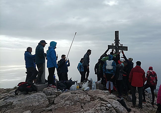 The team of volunteers lifting the cross back onto its rightful place