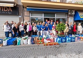The Lions and their supporters with some of the donations collected for the needy.