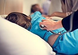 A doctor attending to a child in a hospital.