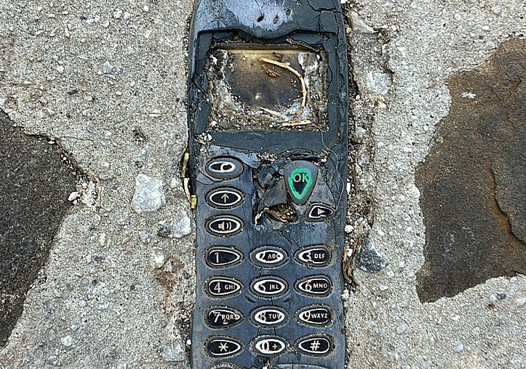 The mobile phone embedded in a pavement in a Malaga village