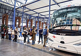 Passengers queue up to board bus that connects Malaga with Madrid.