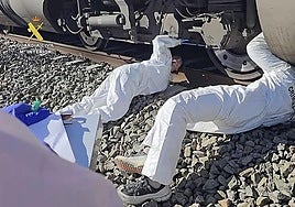 A crime scene officer checks the wheels of the Iryo on Tuesday morning.