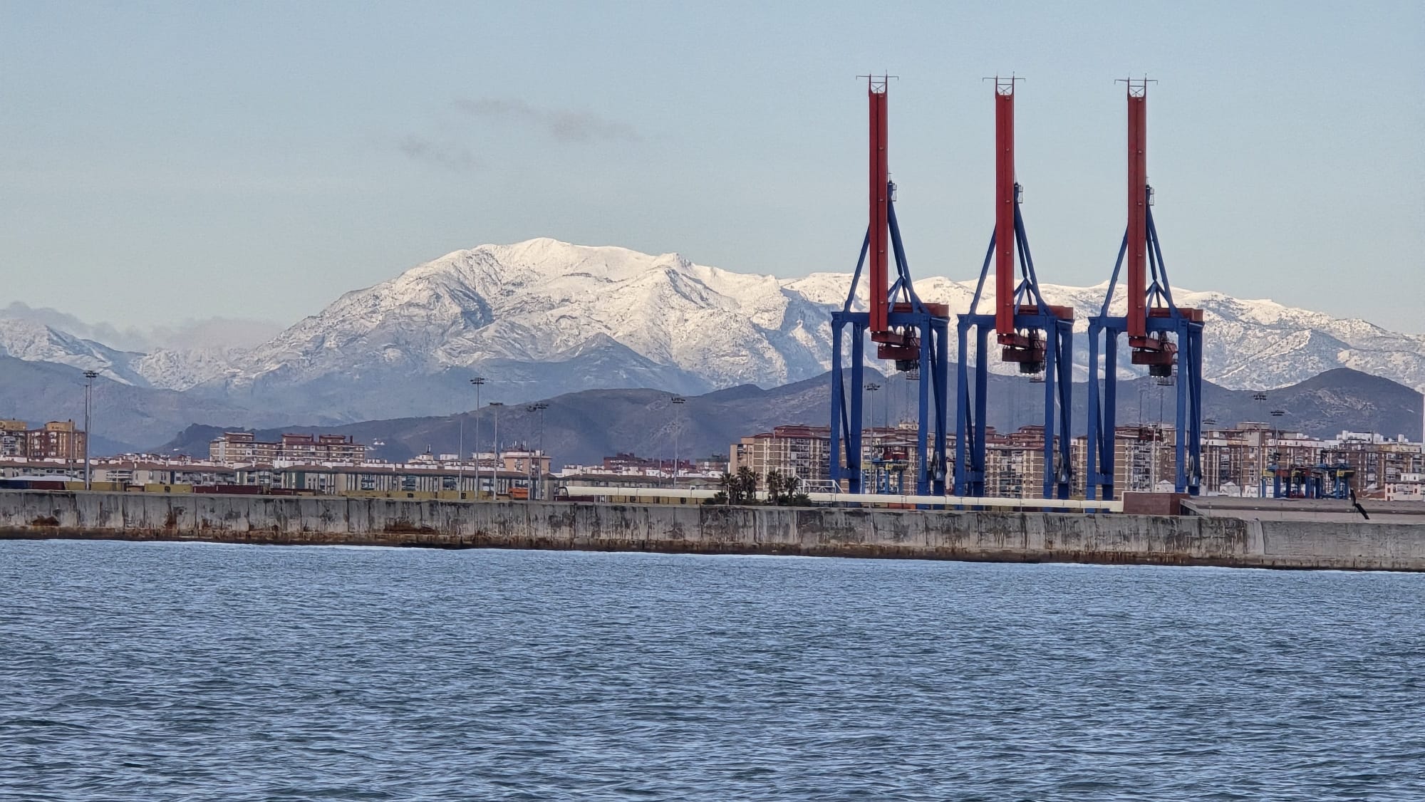 Snow on La Maroma seen from Malaga port. Jabegotes de la Bahía