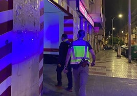 Archive photo of plainclothes officers entering a garage.