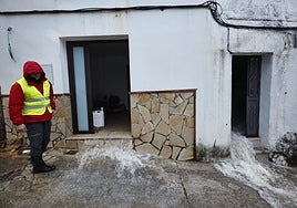 Water cascades out of a flooded house in Benaoján.