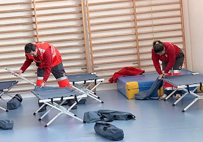 Setting up camp beds in the local school.