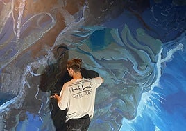 KIWI busy at workpainting the mural atAlmuñécar's aquarium