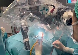 Doctors performing a cochlear implant surgery.