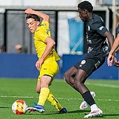 Villarreal B's Hugo López protects the ball under pressure from Torremolinos's Usse Diao.