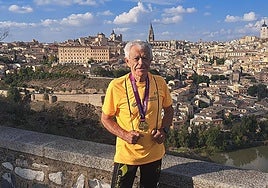 Juan López poses with a medal in Toledo after running a marathon.