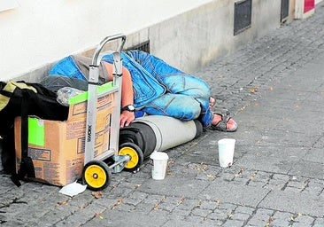 A homeless person sleeping on the street.