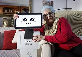 Carmen Navas with robot Temi in her home in Teatinos, Malaga.