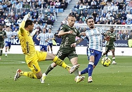 The moment Malaga's Joaquín was brought down by the keeper, who escaped a red card.