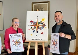 The town's mayor with urban artist D Darko and the new poster.