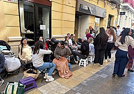 Calle Especería in Malaga was filled with people sitting on folding chairs on Holy Monday.