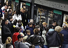 Passengers waiting to get on the metro in Malaga on Holy Monday.