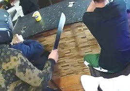 Moment when the assailant breaks into the shop armed with a machete.