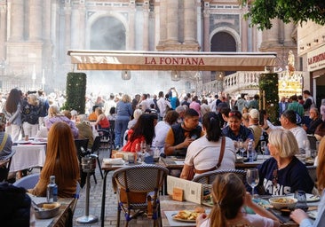 Restaurant customers watching the procession pass in front of the Malaga Cathedral on Easter Sunday.