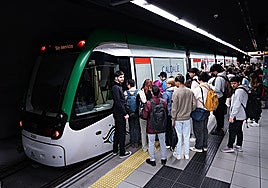 Passengers waiting to board a metro train in Malaga.