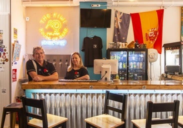 Trish and Tony standing at their Kiwi bar.