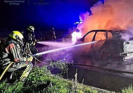 Archive photo of firefighters extinguishing a burning car.
