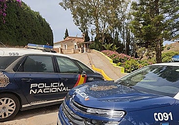 National Police cars near the house in Benajarafe where Eva María's husband killed her in May 2022.