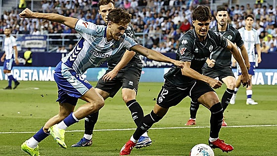 Malaga's Adrián Niño tries to force an opening on Saturday.