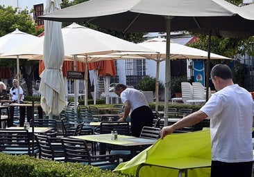 Table staff on an open-air terrace in Marbella.