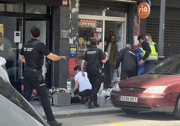 Health workers try to resuscitate a young man stabbed to death in a street in Valencia.