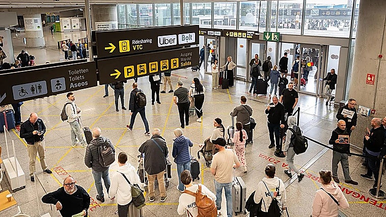 Passengers leaving the Arrivals area at Malaga Airport.