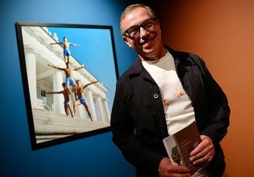 Valery Katsuba, standing in front of one of the images of gymnasts from his exhibition at the Russian Museum.
