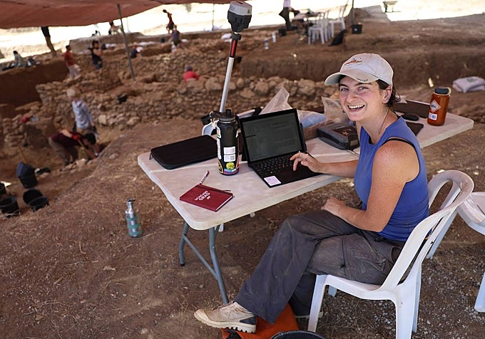 Erin Braner from the US, with her computer at the excavation site.