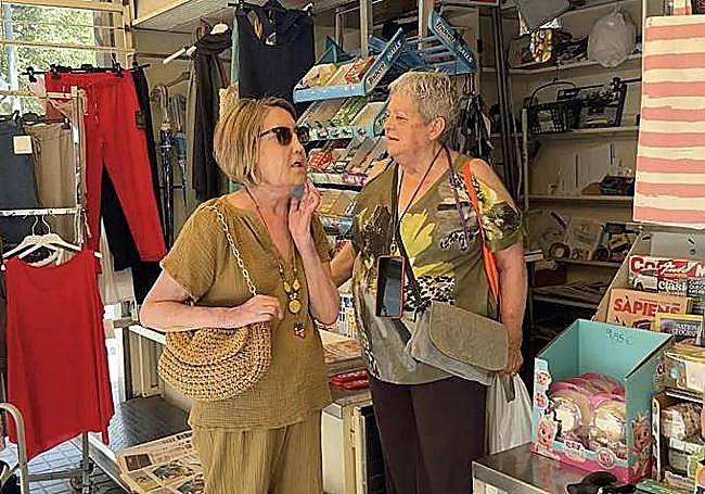 Carmen shows off her new face to a neighbour in her Barcelona neighborhood. Her appearance is looking more natural every day as ongoing reinnervation improves facial movement; it takes months for nerves to reconnect.