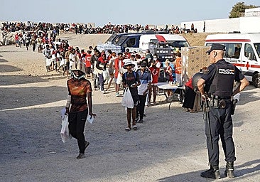 The Red Cross distribute hundreds of food rations to people trying to survive in Ceuta after entering the city illegally at the end of July.