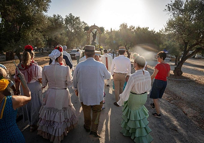 Pilgrims follow the image of the Ancangel San Miguel to the pine forest.