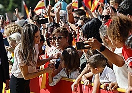 Queen Letizia greets a number of children on her arrival in Melilla.