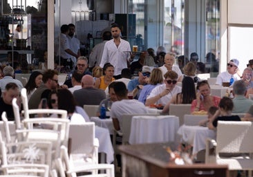 Tourists enjoy the local cuisine at the beach bars.