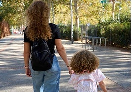 The woman is out for a walk with her 3-year-old daughter.