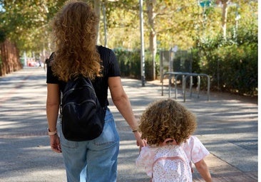 The woman is out for a walk with her 3-year-old daughter.
