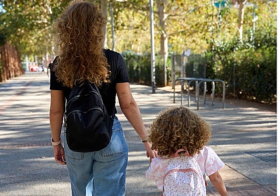 The woman is out for a walk with her 3-year-old daughter.