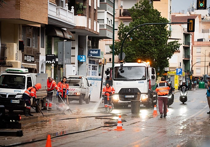 Clearing away the mud that has built up on the streets.