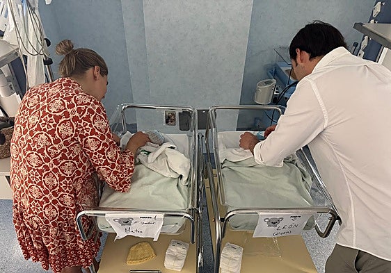 Valle and her husband, with their premature babies, who have been given donated breast milk during their first few days of life.