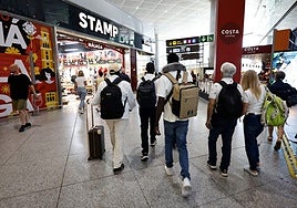 Tourists making their way to their boarding gates at Malaga Airport.