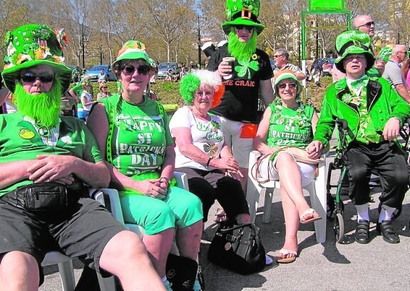 A sea of green hats and coloured wigs.