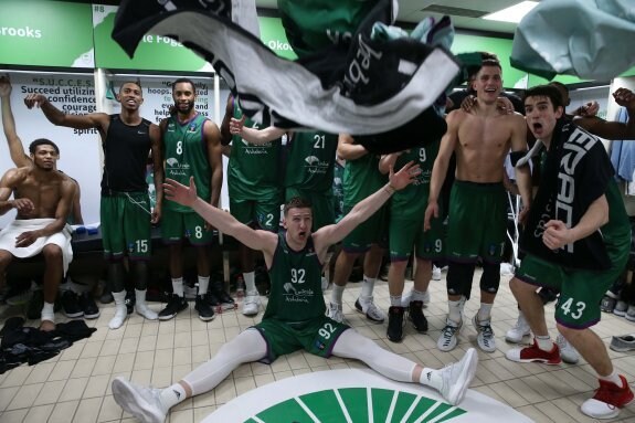 The players celebrating a historic victory in the changing rooms.