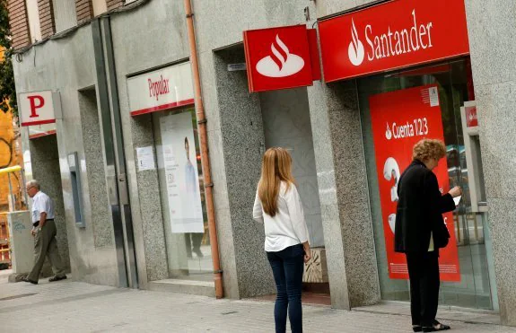 A branch of Popular next to Banco Santander in Barcelona.