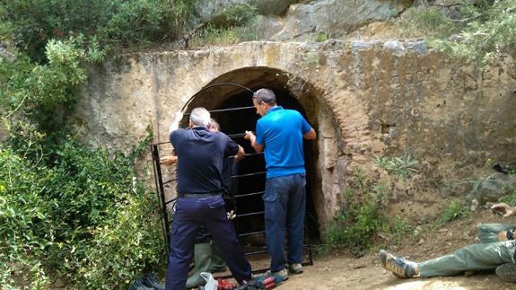 Town hall workers installing the new gate.