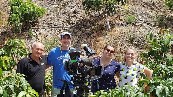Kate Quilton (right) and crew at the mango plantation. 
