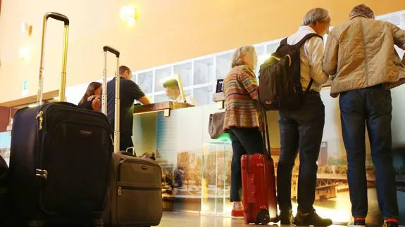 Tourists check in to a Spanish hotel.