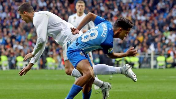 Malaga's Rosales and Cristiano Ronaldo of Real Madrid.